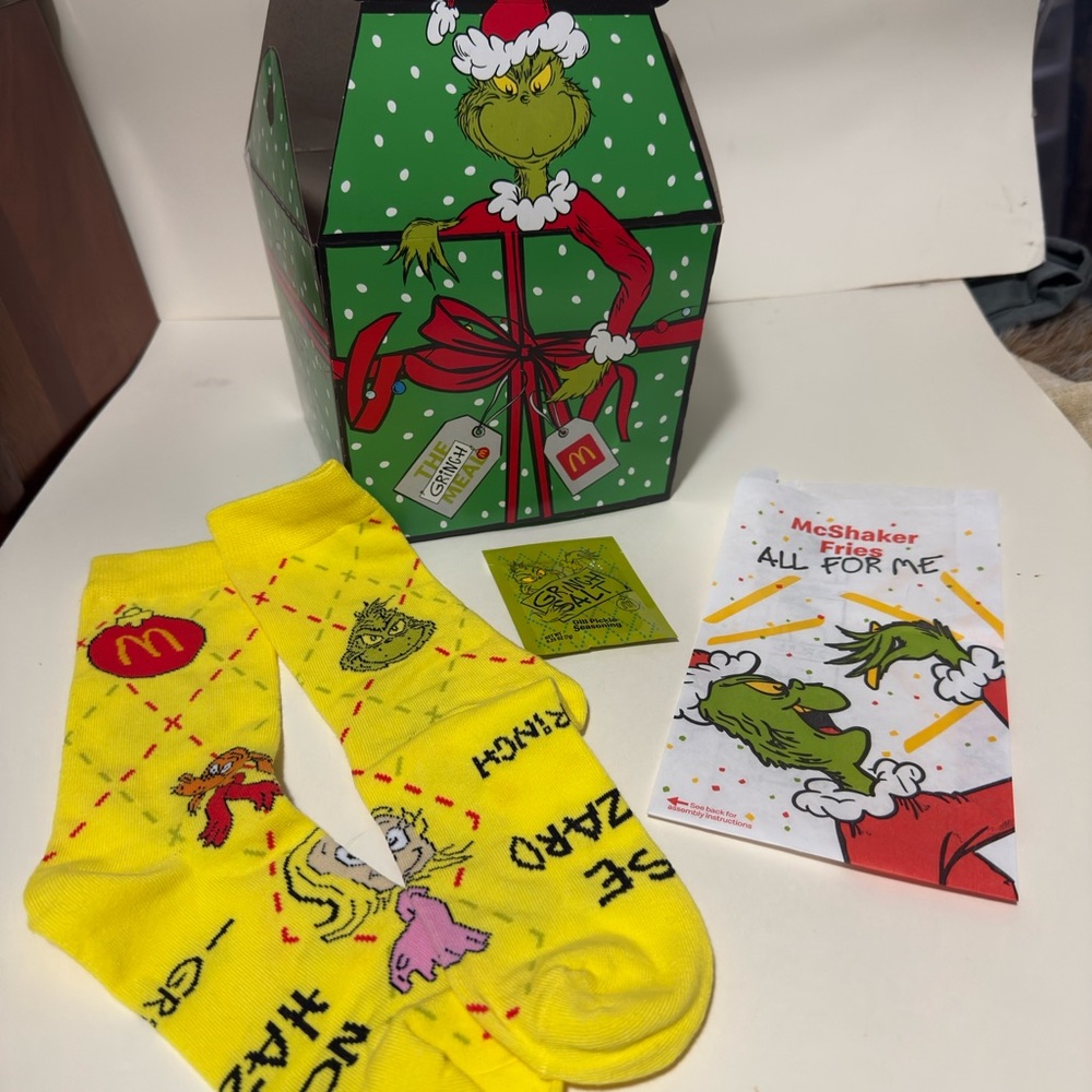 McDonald's Grinch Yellow Casual Socks, box, fry bag, and grinch salt. All unused